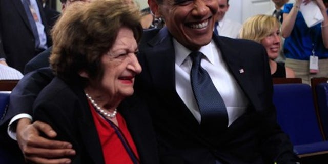 Aug. 4, 2009: President Obama mugs for the camera with Hearst White House columnist Helen Thomas during a mutual birthday celebration in the White House briefing room. (Reuters)