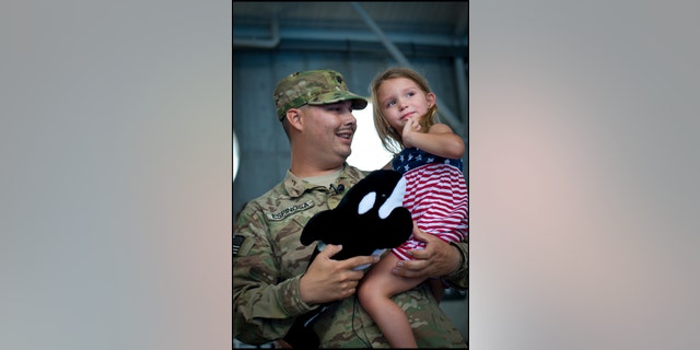 A member of our military is shown here with his daughter enjoying some vacation time earlier in the year. The USO helps Americans reach out to the men and women who are serving our country and are separated from loved ones during the Christmas season. 