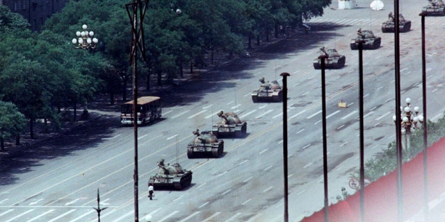 A man blocking tanks