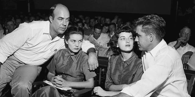 In this Sept. 23, 1955, file photo, J.W. Milam, left, his wife, second left, Roy Bryant, far right, and his wife, Carolyn Bryant, sit together in a courtroom in Sumner, Miss. 