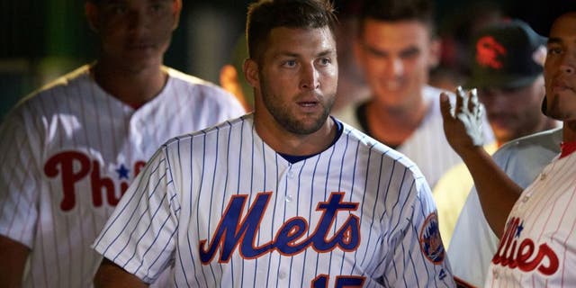 Scottsdale Scorpions left fielder Tim Tebow (15), of the New York Mets organization, in the dugout during a game against the Salt River Rafters on Oct. 12, 2016, at Scottsdale Stadium in Scottsdale, Arizona. Salt River defeated Scottsdale 6-4. (Mike Janes/Four Seam Images via AP)