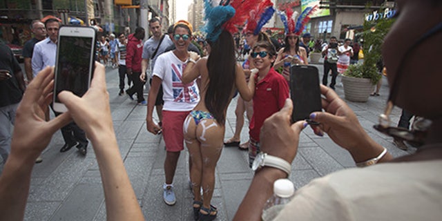 Times Square performers, including the "desnudas," are limited to a Designated Activity Zone -- but many of them reportedly venture outside the zone.
