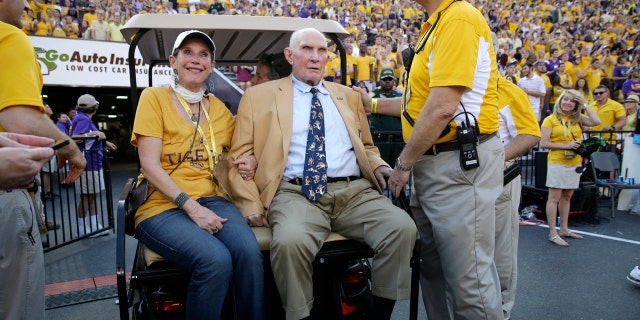 In this Sept. 20, 2014, file photo, NFL great and LSU alumnus Y.A. Tittle, center, arrives in Tiger Stadium in the first half of an NCAA college football game between LSU and Mississippi State, in Baton Rouge, La.