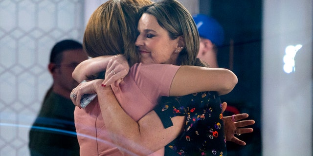 Co-anchors Hoda Kotb, left, and Savannah Guthrie embrace on the set of the "Today" show Wednesday, Nov. 29, 2017, in New York, after NBC News fired host Matt Lauer. NBC News announced Wednesday, Nov. 29, 2017, that Lauer was fired for "inappropriate sexual behavior." (AP Photo/Craig Ruttle)