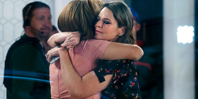 Co-anchors Hoda Kotb, left, and Savannah Guthrie embrace on the set of the "Today" show Wednesday, Nov. 29, 2017, in New York, after NBC News fired host Matt Lauer. NBC News announced Wednesday, Nov. 29, 2017, that Lauer was fired for "inappropriate sexual behavior." (AP Photo/Craig Ruttle)