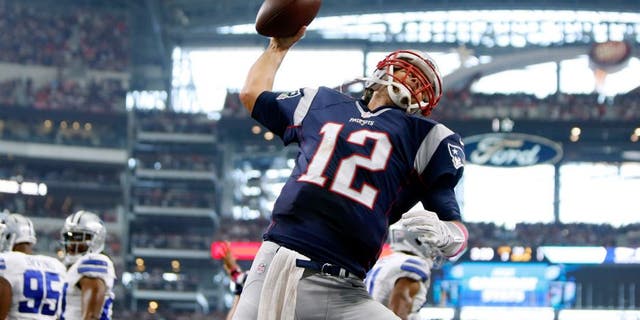 Oct 11, 2015; Arlington, TX, USA; New England Patriots quarterback Tom Brady (12) celebrates scoring a touchdown against the Dallas Cowboys at AT&T Stadium. Mandatory Credit: Erich Schlegel-USA TODAY Sports