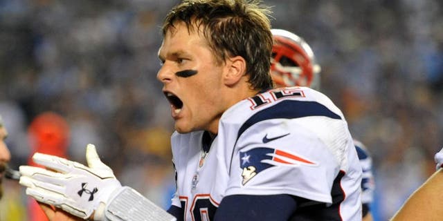 Dec 7, 2014; San Diego, CA, USA; New England Patriots quarterback Tom Brady (12) reacst on the sideline against the San Diego Chargers during the fourth quarter at Qualcomm Stadium. Mandatory Credit: Jake Roth-USA TODAY Sports
