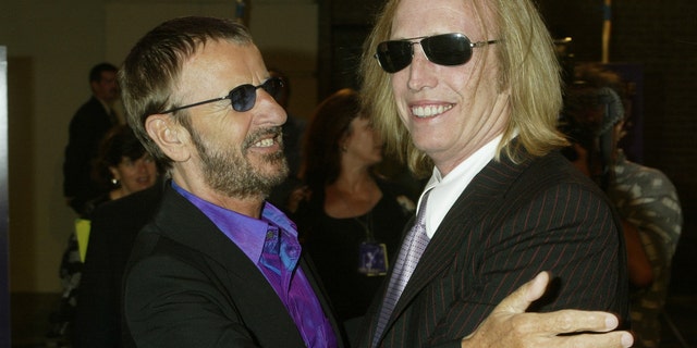 Musician Ringo Starr, former member of "The Beatles" (L) greets musician Tom Petty as he arrives for a screening of "Concert for George", a new documentary film celebrating the music of George Harrison through performances by legendary musicians McCartney, Ringo Starr, Billy Preston and Tom Petty and the Heartbreakers, at Warner Bros. studios in Burbank, California September 24, 2003.