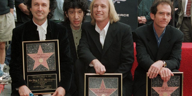 Veteran rockers Tom Petty and the Heartbreakers are shown at the Walk of Fame ceremony in Hollywood April 28, 1999. From l-r: Mike Campbell, Howie Epstein, Tom Petty and Benont Tench.