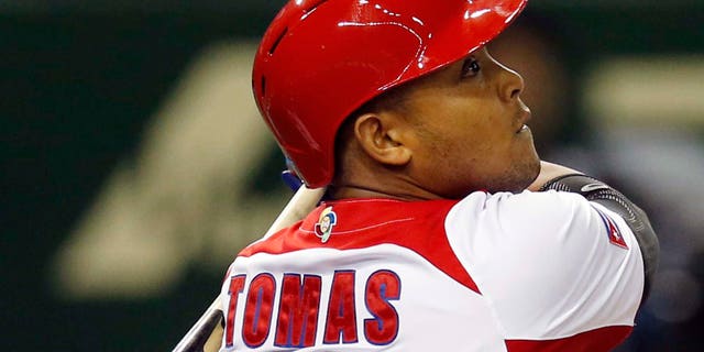 FILE - In this March 9, 2013, file photo, Cuba's Yasmany Tomas hits a three-run home run off Taiwan pitcher Yang Yao-hsun in the fourth inning of their World Baseball Classic second-round game in Tokyo. Tomas can become a free agent again after receiving $36 million during the first four years of his contract with the Arizona Diamondbacks. Under the agreement announced Monday, Dec. 8, 2014, the Cuban defector is guaranteed $68.5 million over six seasons. (AP Photo/Koji Sasahara, File)