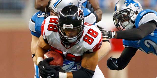 Atlanta Falcons tight end Tony Gonzalez (88) is tackled by Detroit Lions outside linebacker Bobby Carpenter (59), Amari Spievey, right, and linebacker Stephen Tulloch (55) in the third quarter of an NFL football game in Detroit, Sunday, Oct. 23, 2011. Gonzalez had five receptions for 62 yards to pass Marvin Harrison for second place on the NFL career receptions list. (AP Photo/Rick Osentoski)
