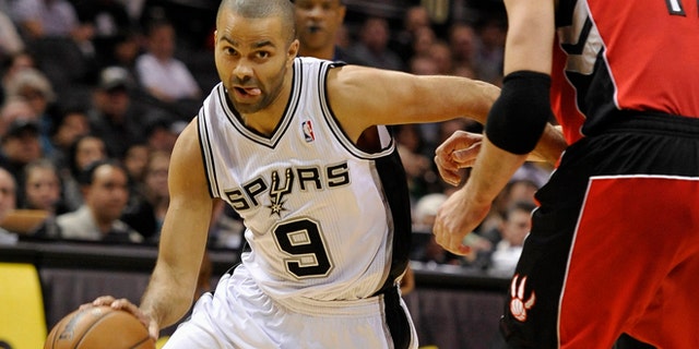 Dec. 23, 2013: San Antonio Spurs point guard Tony Parker, left, of France, drives around Toronto Raptors center Jonas Valanciunas, of Lithuania, during the first half of an NBA basketball game in San Antonio.