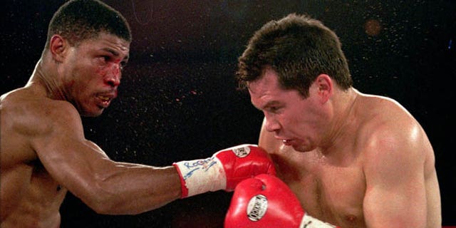 March, 29,1997: In this file photo, Tony Martin, left, of Philadelphia, punches Mexico's Julio Cesar Chavez in the second round of their Welterweight Special Attraction fight, in Las Vegas. Police say that Martin, a former welterweight, was fatally shot Friday, March 8, 2013, in an altercation with a visitor at one of his rental properties in Philadelphia.  He was 52.