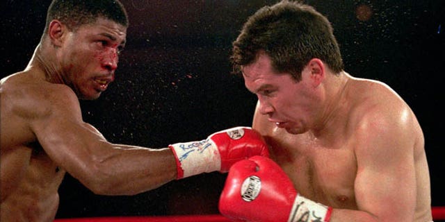 March, 29,1997: In this file photo, Tony Martin, left, of Philadelphia, punches Mexico's Julio Cesar Chavez in the second round of their Welterweight Special Attraction fight, in Las Vegas. Police say that Martin, a former welterweight, was fatally shot Friday, March 8, 2013, in an altercation with a visitor at one of his rental properties in Philadelphia. He was 52.