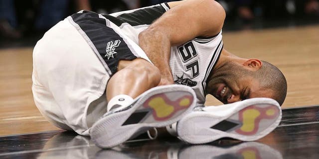 In this Wednesday, May 3, 2017 photo, San Antonio Spurs' Tony Parker holds his left leg after getting injured in the second half of Game 2 of the Western Conference semifinals at the AT&amp;T Center against the Houston Rockets in San Antonio. The Spurs announced on Thursday, May 4, 2017, that Parker has a ruptured quadriceps tendon in his left leg. (Jerry Lara/The San Antonio Express-News via AP)