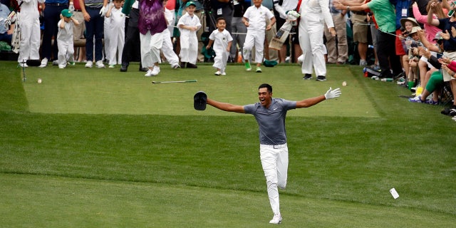 Tony Finau reacts to his hole-in-one at the Masters Par-3 contest seconds before turning his ankle Wednesday.