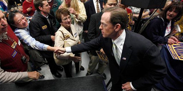 In this Oct. 22 photo, Pennsylvania Republican Senate candidate Pat Toomey meets with supporters at a rally in Blue Bell, Pa. (AP Photo)