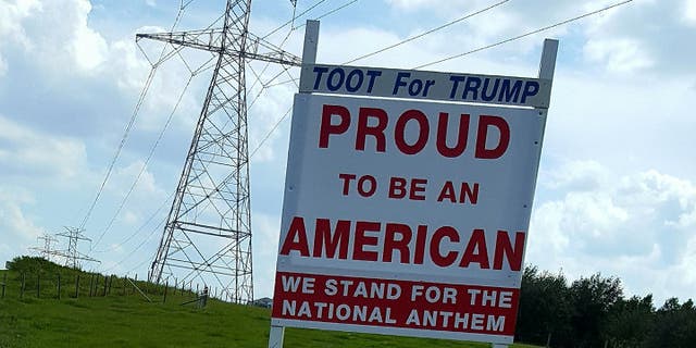 Simmons' most recent sign, which gained attention, said: "We stand for the national anthem."