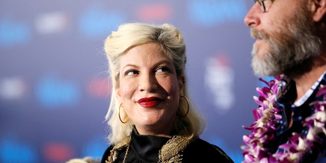 Actor Tori Spelling and husband Dean McDermott pose at the world premiere of Walt Disney Animation Studios' "Moana" as a part of AFI Fest in Hollywood, California, Nov. 14, 2016.