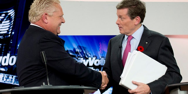 Oct. 23, 2014: Toronto mayoral candidates Doug Ford, left, and John Tory shake hands during the final mayoral debate for the Toronto mayoral race in Toronto.