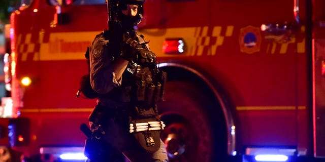 A tactical officer works the scene of a shooting, Sunday, July 22, 2018, in Toronto. (Frank Gunn/The Canadian Press via AP)