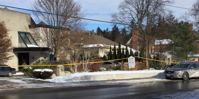 Police tape surrounds the home of billionaire Barry Sherman on Saturday, Dec. 17 2017, in Toronto.