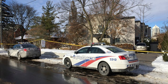 Police cars are parked outside the home of billionaire Barry Sherman on Saturday, Dec. 17, 2017 in Toronto.