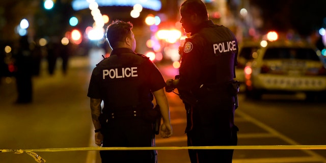 Police work the scene of a shooting in Toronto on Sunday, July 22, 2018.