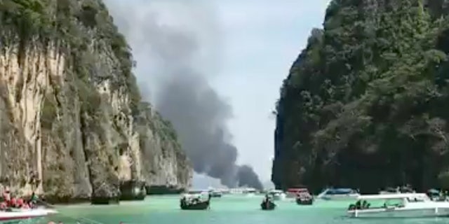 Smoke rises from a tourist speedboat after its explosion in Phi Phi Islands, Thailand, January 14, 2018 in this still image taken from a video obtained from social media.
