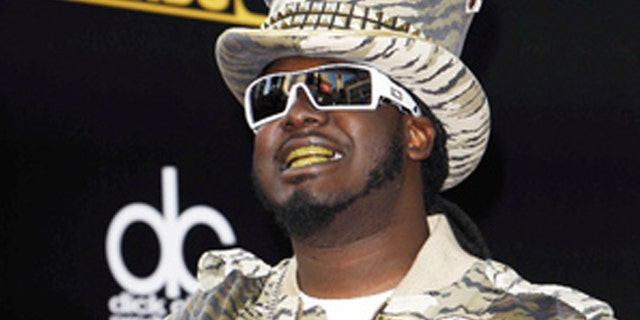 Rapper T-Pain's security guard was detained at the Atlanta airport after trying to go through security with a gun.