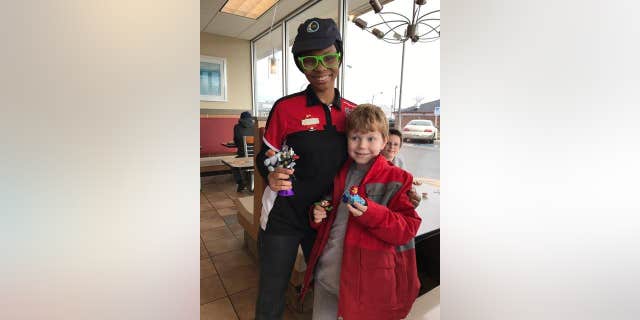 Leif poses with his Teen Titans toy and TQ, who made sure he got it.