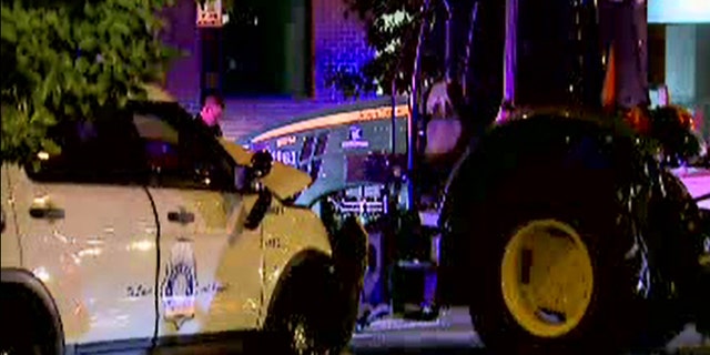 Two police officers were injured in a slow-speed chase with a John Deere tractor in downtown Denver on Friday night, police said.