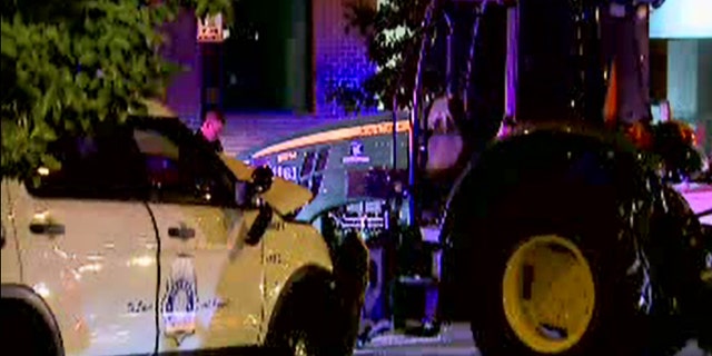 Two police officers were injured in a slow-speed chase with a John Deere tractor in downtown Denver on Friday night, police said.