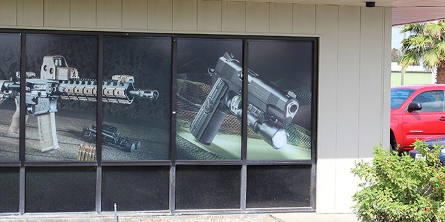 Michael Baryl, of Tracy Rifle & Pistol, has until February to take down this window display to comply with a Bureau of Firearms order. (Photo: Tracy Rifle and Pistol)