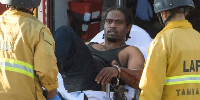 A suspect is arrested after evading police and holding dozens of people hostage inside a Trader Joe's supermarket in Los Angeles, July 21, 2018.
