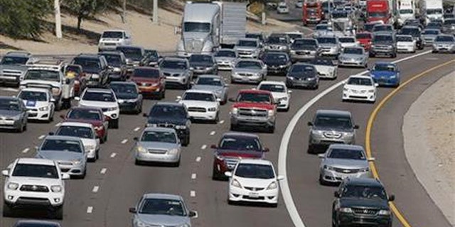 Low gas prices and an improving economy will prompt Americans to hit the road for the Fourth of July.