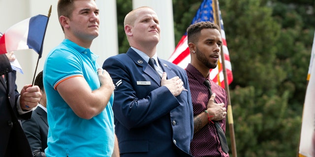 Alek Skarlatos, left, U.S. airman Spencer Stone, center, and Anthony Sadler attend a parade in Sacramento, California, Sept. 11, 2015.