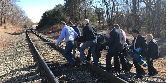 Lawmakers are seen carrying an injured victim after the train crash en route to the GOP retreat.