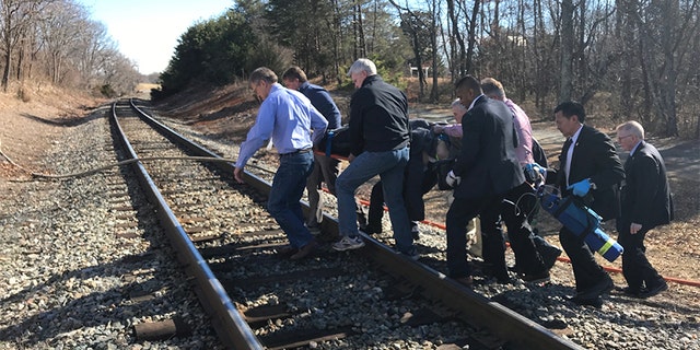 Lawmakers are seen carrying an injured victim after the train crash en route to the GOP retreat.