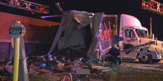 The semi-truck split in two when the train struck it.