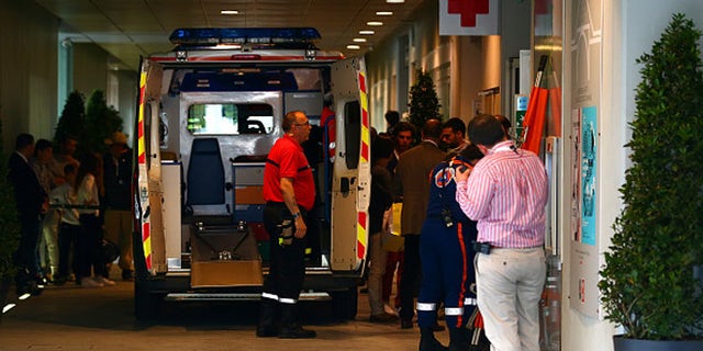 PARIS, FRANCE - JUNE 02: An ambulance waits to transport an injured spectator to hospital after a piece of the scoreboard above Court Philippe Chatrier was blown off in high winds during the men's singles quarterfinal match between Kei Nishikori of Japan and Jo-Wilfried Tsonga of France on day of the 2015 French Open at Roland Garros on June 2, 2015 in Paris, France. (Photo by Dan Istitene/Getty Images)