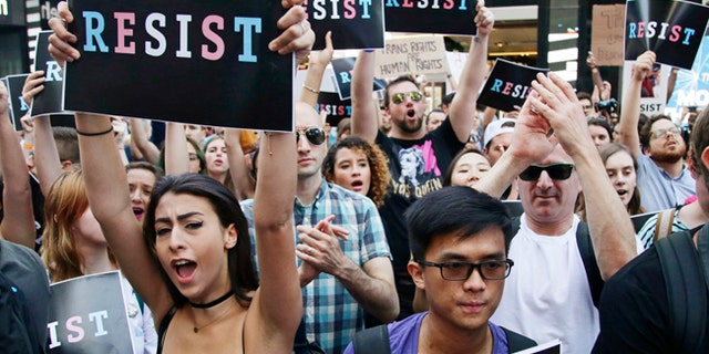 Protesters attend a New York City rally against President Trump's ban on transgender people serving in the U.S. military.