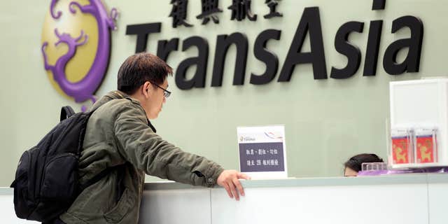 Feb. 7, 2015: A passenger waits at the ticket counter of TransAsia Airways at the Songshan Airport in Taipei, Taiwan.