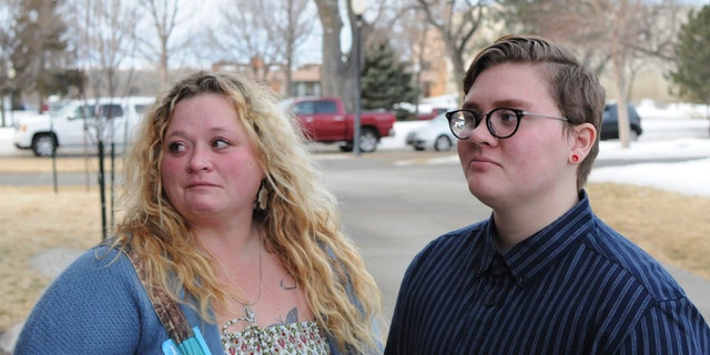 Jessie Lamphere, a transgender high school student, stands with his mom, Tyler Lamphere, left, after a brief hearing at the state Capitol in Pierre, S.D., Tuesday, Jan. 31, 2017. A bill that would have restricted which locker rooms South Dakota transgender students could use was withdrawn Tuesday. (AP Photo/James Nord)