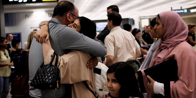 Family members embrace after arriving at Washington Dulles International Airport in Dulles, Va., after the Supreme Court's decision.