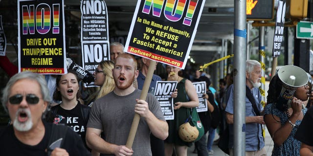 Activists march in protest against the U.S. Supreme Court's decision to revive parts of a travel ban in New York City.