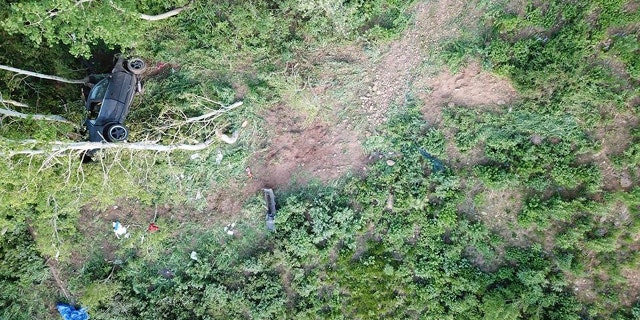 A car that crashed off a mountain road in northern Utah and landed in a tree, injuring seven teenagers from the Ogden area on Thursday, June 14, 2018, is pictured in this photo provided by the Weber County Sheriff's Office. Sheriff's deputies say the car was traveling 70 mph in a 40 mph zone on State Highway 39 near Monte Crisco when it went off a curve and landed 180 feet below. (Weber County Sheriff's Office via AP)
