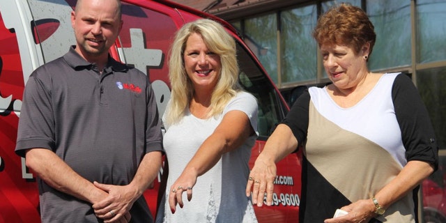 Trent Dawson, left, is pictured here with Cherie Kissiar, center, and Connie Keck, right, after giving them back their long-lost class rings.