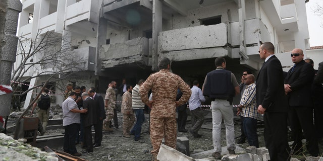 April 23, 2013: Security officers and officials inspect the site of a car bomb that targeted the French embassy wounding two French guards and causing extensive material damage in Tripoli, Libya.