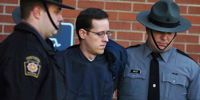 FILE - In this Jan. 5, 2015, file photo, Eric Frein is led away by Pennsylvania State Police Troopers at the Pike County Courthouse after his preliminary hearing in Milford, Pa. Attorneys for Frein, charged in the 2014 ambush slaying of Pennsylvania Police Cpl. Bryon Dickson II, are asking a judge on the eve of his trial to throw out his videotaped confession. (Butch Comegys/The Times & Tribune via AP, File)